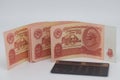 Pair of glasses and money on a red background. Selective focus.. Old banknotes of the former Soviet Union. USSR - rubles Royalty Free Stock Photo