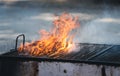 Old barbeque grill with fire flames coming out Royalty Free Stock Photo