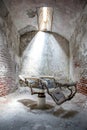 Old barber chair in an abandoned jail cell Royalty Free Stock Photo