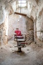 Old barber chair in an abandoned jail cell Royalty Free Stock Photo