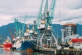 Old Barge Freight Ship Tanker And Heavy Loading Cranes Jib In Port