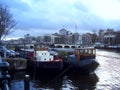 Old barges on the canals of Amsterdam in Holland.