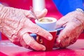 The old barista takes away the coffee cups to wash them