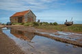 Old barn and abandoned boat in England. Royalty Free Stock Photo