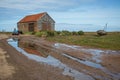 Old barn and abandoned boat in England. Royalty Free Stock Photo