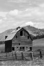 Old barn and abandoned homestead on a green grassy hillside Royalty Free Stock Photo