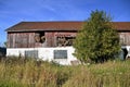 Old barn with bales sticking out of hay loft