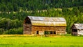 Old barn build from logs in a farmers field along the Coldwater Road between Hope and Merriit Royalty Free Stock Photo