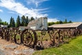 Old barn with fence made from old steel wheels Royalty Free Stock Photo