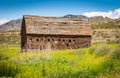 Old barn in green field falling apart Royalty Free Stock Photo