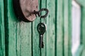 Old barn locks with keys hang on the painted green wood wall. Royalty Free Stock Photo