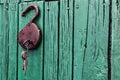 Old barn locks with keys hang on the painted green wood wall. Royalty Free Stock Photo