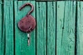 Old barn locks with keys hang on the painted green wood wall. Royalty Free Stock Photo