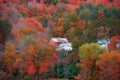 Barn in mountains surrounded by bright fall foliage Royalty Free Stock Photo