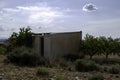 Old barn in olive and almond grove of barranco Hondo in Gojar, village at the foot of Granada, Andalusia, Spain