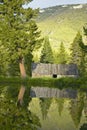 Old barn with reflection of large tree in pond at Taft Ranch, Centennial Valley, MT, Royalty Free Stock Photo