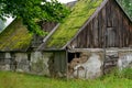 An old barn with a roof covered with moss Royalty Free Stock Photo