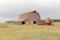 Old barn and swather in a farmyard