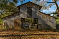 OLD BARN WITH OLD TRACTOR AND CAR Royalty Free Stock Photo