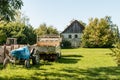 Old barn, tractor and farm machinery in green field Royalty Free Stock Photo