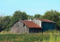 Old barn w/rust colored roof.