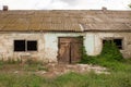 An old barn with a wooden barn door in an agricultural farm. Barn with vibrant green wall and old wooden barn door Royalty Free Stock Photo