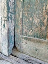 Closeup Detail of an Old Barn Door Bottom Painted Green, now Peeling and Weathered Wood