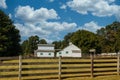 Old Barns with Green Shutters Past Fence Royalty Free Stock Photo