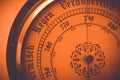 Old barometer dial close up with added orange filter Royalty Free Stock Photo