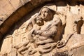 An old baroque engraved sculpture of Mary and Jesus over an entrance to the Cappella della Croce di Giorno in Volterra