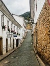 Old baroque houses in narrow stone made street at Ouro Preto city, state of Minas Gerais, Brazil