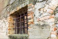 Old barred window. Ancient medieval construction.