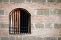 Old Barred Window on a Brick and Stone Wall Royalty Free Stock Photo