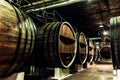 Old barrels in the wine cellar. Wine cellar with old oak barrels, production of fortified dry or semi-sweet wine. Royalty Free Stock Photo