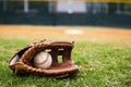 Old Baseball and Glove on Field Royalty Free Stock Photo