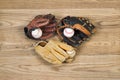 Old Baseball Gloves and balls on aged wood