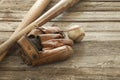 Old baseball, mitt and bats on a rough wood surface