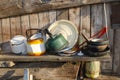 Old and basic kitchen with cooking utensils hung on wood board wall of traditional wooden house