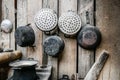 Old and basic thai kitchen with cooking utensils hung on wood board wall