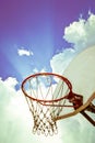 Old basketball board and hoop on blue sky with clouds background Royalty Free Stock Photo