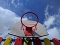 old basketball hoop against a background of blue sky and clouds Royalty Free Stock Photo