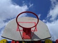 old basketball hoop against a background of blue sky and clouds Royalty Free Stock Photo