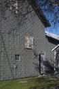 Old Basketball hoop attached to a grey barn