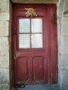 Old Basque door of red wood and `eguzkilore` 2 Royalty Free Stock Photo