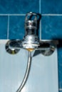 Old Bathroom Sink Faucet contaminated with calcium and grime. Hard water dripping from an old tap aerator Royalty Free Stock Photo