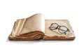 An old, battered book, with glasses on yellowed pages on a white background Royalty Free Stock Photo