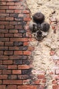 An old battered brick red wall with white plaster and a rusty broken bell Royalty Free Stock Photo