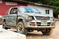 Old battered pickup truck parked near the house. Rural transport