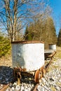 Old battered rusty bucket trolley on a rail track Royalty Free Stock Photo