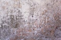 Old battered white concrete wall with cracks and stains of dark paint and mold. rough surface texture Royalty Free Stock Photo